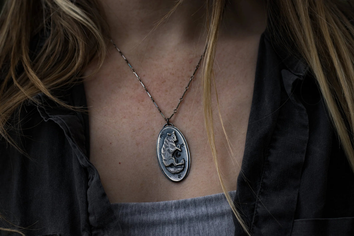 Celestial Canines - Silver Amulet, side view