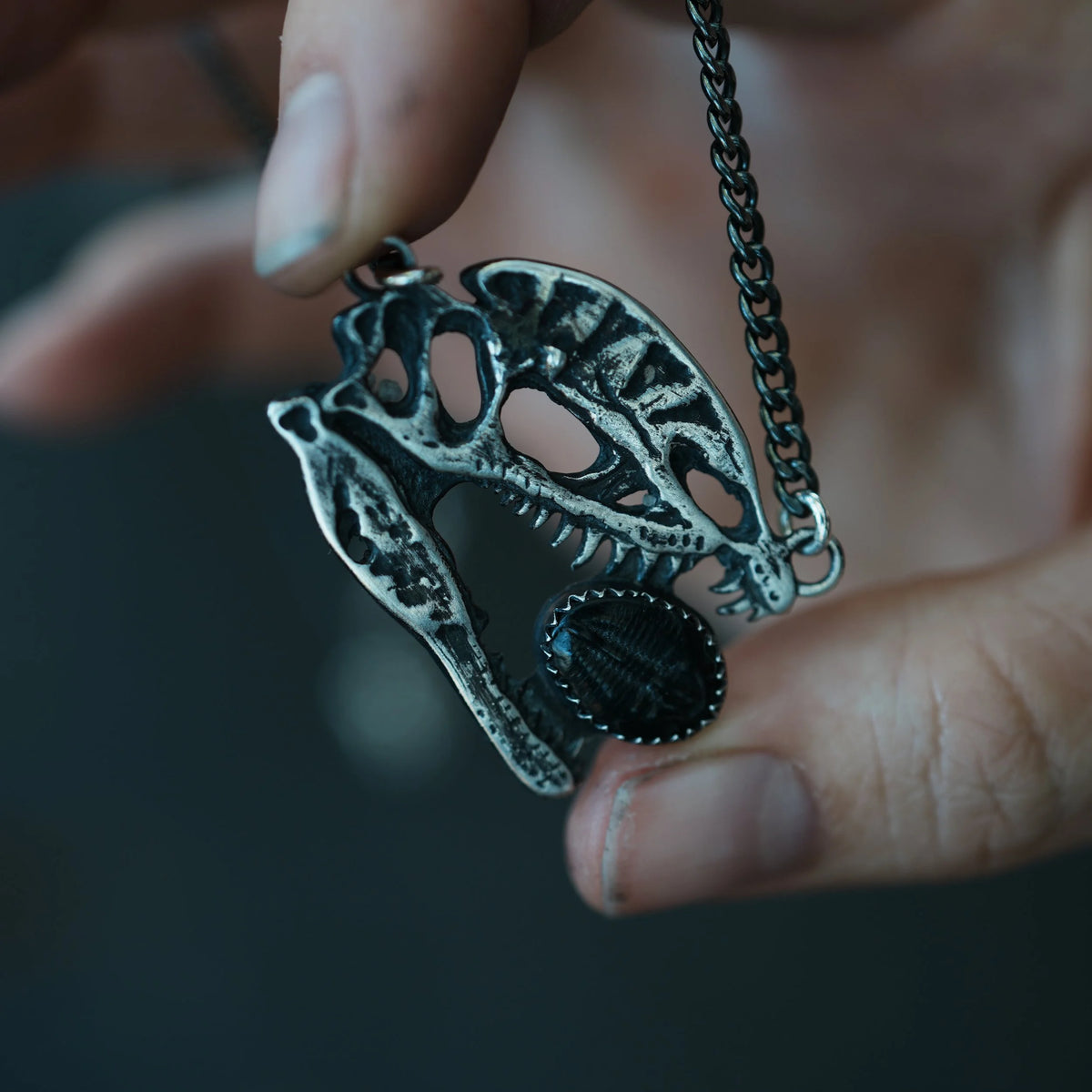Dilophosaurus Skull - Trilobite Necklace, close-up detail