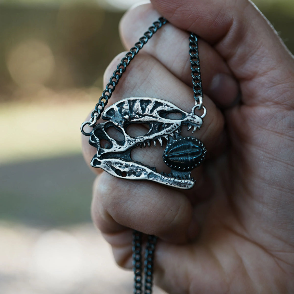 Dilophosaurus Skull - Trilobite Necklace, detail view