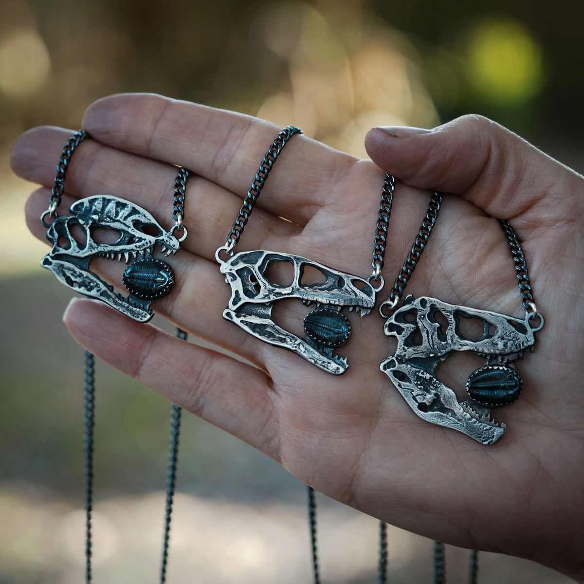 Dilophosaurus Skull - Trilobite Necklace, side view